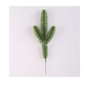 Detailed view of an artificial three-pronged green pine needle branch for Christmas.