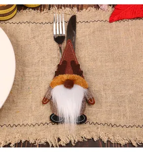 Close-up detail of a charming Christmas gnome felt cutlery holder with knife and fork