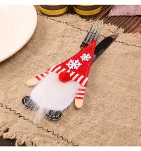 Detailed view of a cute red Christmas gnome cutlery holder for festive table settings