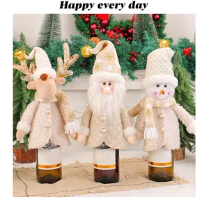 Cream-colored Christmas wine bottle covers featuring reindeer, Santa, and snowman designs