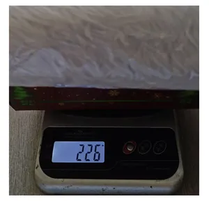 Detailed view of a digital scale measuring the 226g weight of the plush Christmas tree skirt