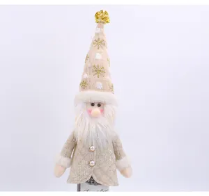 Detailed close-up of a decorative knitted Santa Claus wine bottle cover with gold sequins