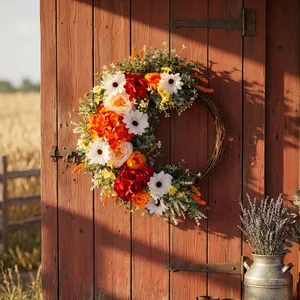 Rustic artificial flower wreath on a red barn door for home and holiday wall decor