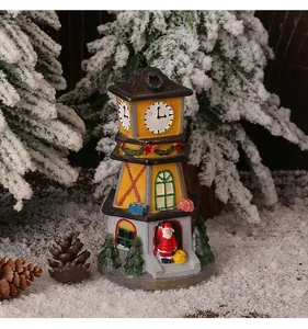Detailed view of a festive miniature LED Christmas resin clock tower with a Santa figure