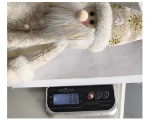 Close-up showing the 66g weight of this cute Santa Claus wine bottle cover decoration