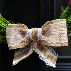Rustic burlap bow wreath with elegant white lace trim for farmhouse wedding and home wall decor