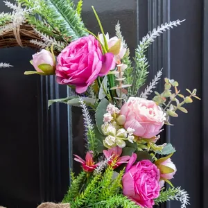 Realistic artificial pink rose wreath with green ferns for home wall decoration