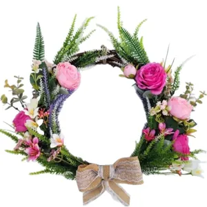 Handmade artificial flower wreath with pink roses and burlap bow for wedding decor