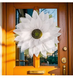 White burlap sunflower wreath hanging on a classic wooden door for home decoration