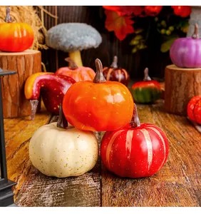 Detailopname van diverse kunstmatige schuimpompoenen in feestelijke herfstkleuren