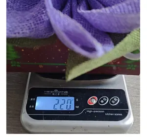 Detailed view of burlap sunflower wreath weight on digital scale showing 220 grams for shipping