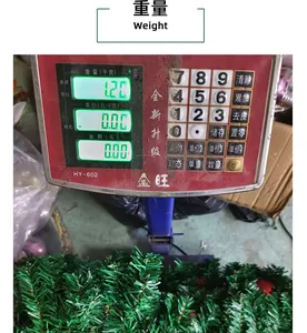 Detail of a 1.20kg PVC Christmas garland on a scale showing weight specifications