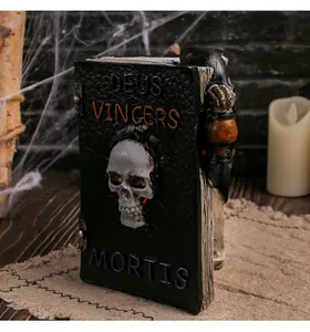 Detailed view of resin Halloween skull book model with DEUS VINCERS MORTIS text