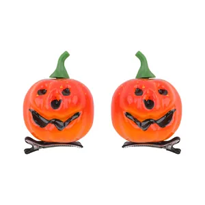 Paire de barrettes citrouille d'Halloween avec un joli visage souriant pour fêtes