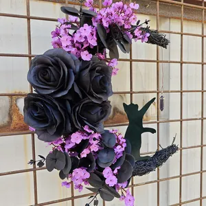 Detailed view of Halloween moon wreath with black roses, purple flowers, and a cat silhouette.
