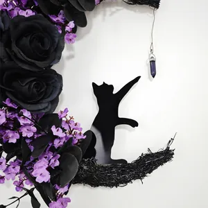 Detailed view of Halloween moon wreath with black roses and a mysterious cat silhouette