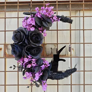 Close-up of Halloween moon wreath with black roses, purple flowers and cat silhouette