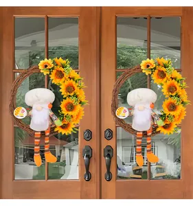 Decorative sunflower wreaths featuring chef gnomes hung symmetrically on a double glass door