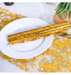 Detailed view of a glittering gold bronzing mesh roll for festive party table runner decoration