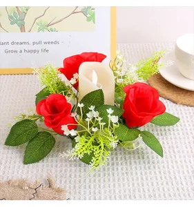 Close-up of red rose candle wreath with white LED candle detail