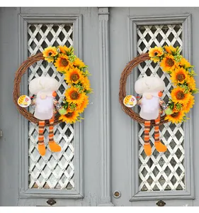 Detail shot of a decorative sunflower chef gnome wreath displayed on a grey vintage door