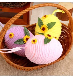 Three colorful woven Easter egg ornaments with sunflower decor in a rustic basket