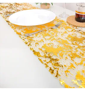 Detailed view of elegant gold foil mesh table runner for festive party dining decor