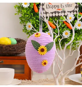 Detailed view of a woven purple Easter egg hanging ornament with vibrant sunflower accents