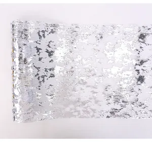 Close-up detail of silver foil mesh fabric roll for shimmering table runner decoration