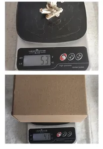 Macro view showing the 53g weight of the skeleton yoga figurine and cardboard box