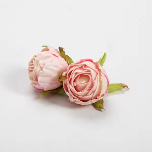 Macro view of vintage pink silk rosebuds featuring realistic fabric texture and green sepals