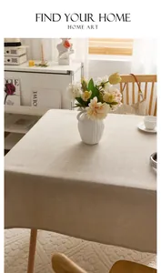 Detailed view of premium thick linen tablecloth with natural woven texture on table