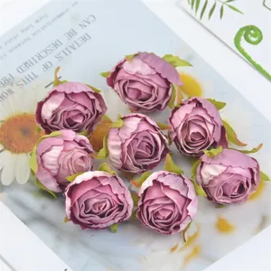 High-detail close-up of vintage burnt-edge silk rose buds in dusty pink for DIY decor