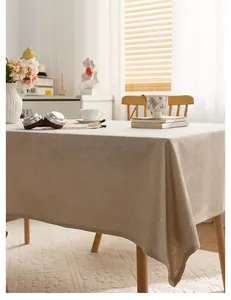 Rustic beige linen tablecloth detail showing high-quality woven fabric texture on a dining table