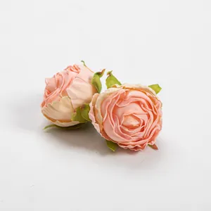 Detailed close-up of vintage burnt edge peach silk rose buds for handmade DIY crafts