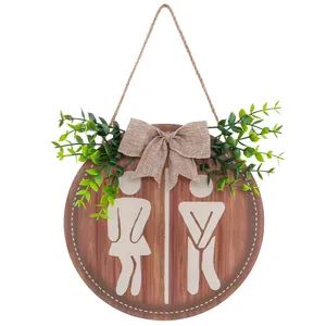 Farmhouse style round wooden bathroom sign with gender silhouettes and greenery
