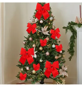 Grandi fiocchi decorativi festivi in velluto rosso appesi a un albero di Natale