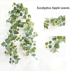 Close-up of green eucalyptus apple leaf garland with delicate white baby's breath flowers