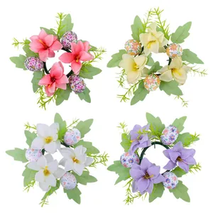 Easter egg candle holder wreaths with artificial lilies and floral eggs for table decor