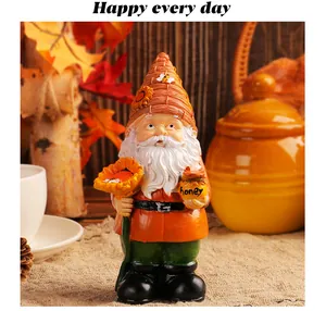 Close-up of a decorative resin garden gnome figurine holding a sunflower and honey pot
