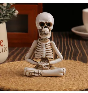 Detailed view of resin meditating skeleton figurine for Halloween home office decor