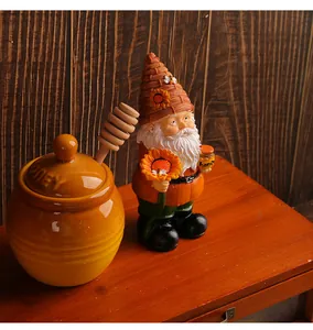 Detailed view of a handcrafted resin garden gnome holding a sunflower and honey jar