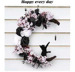 Gothic Halloween moon wreath with black and white roses and black cat silhouette decor