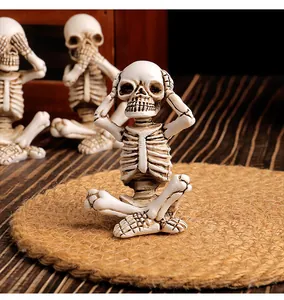 Close-up view of resin skeleton figurines set for Halloween tabletop decoration