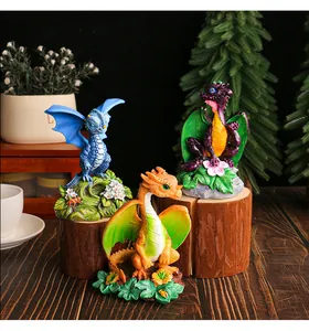 Set of three colorful resin dragon figurines displayed on wooden stumps for garden decor