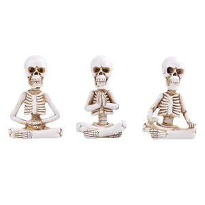 Three-piece set of resin meditating skeleton figurines for Halloween desktop decoration.