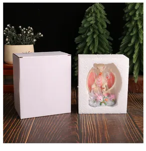 Detailed view of the cute resin dragon figurine with its protective white box and styrofoam packaging.