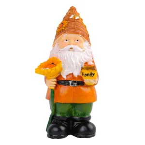 Handcrafted resin garden gnome holding a sunflower and honey pot for outdoor decor.