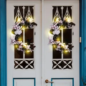 Crescent moon Halloween wreath with black cat, white roses and glowing LED lights on door