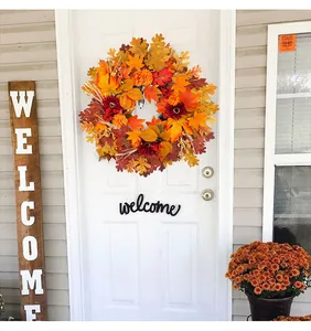 Fall maple leaf and sunflower wreath hanging on a white front door as home decor
